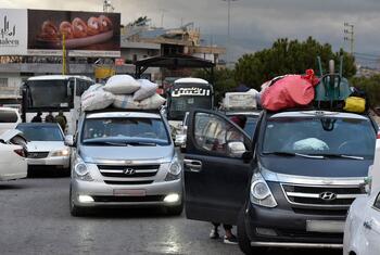 Cars loaded with luggage and belongings wait in a queue at the Masnaa border point in Lebanon, as people flee conflict and Israeli bombing to cross into Syria.