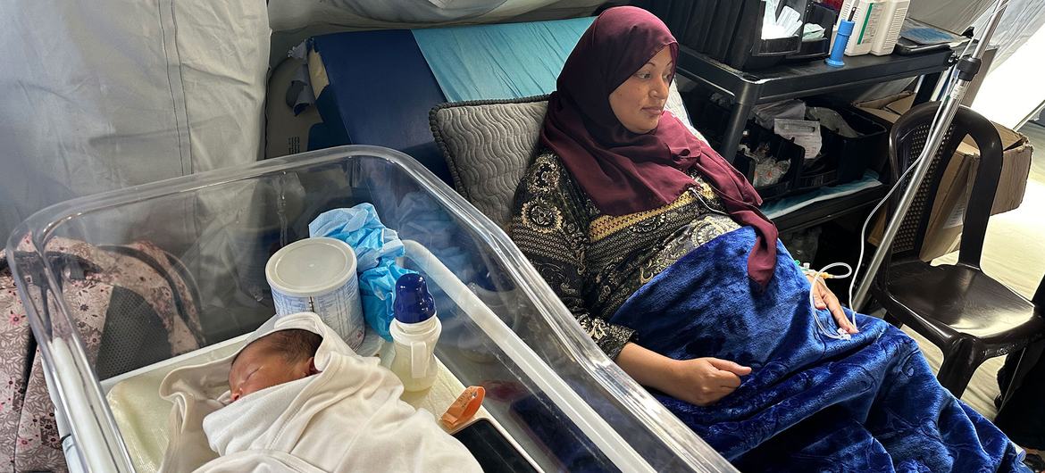 A woman who has recently given birth rests in a medical tent at Al Mawasi Field Hospital in Rafah in the Gaza Strip.