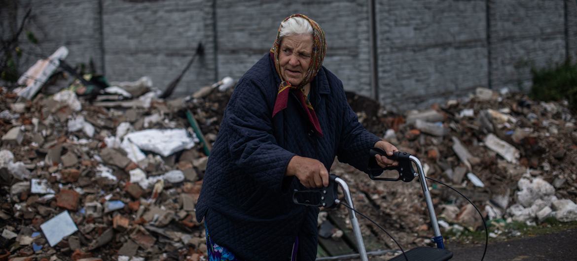 An older woman walks through the destroyed streets of Chernihiv, Ukraine.