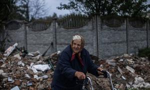 An older woman walks through the destroyed streets of Chernihiv, Ukraine.