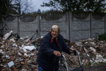 An older woman walks through the destroyed streets of Chernihiv, Ukraine.