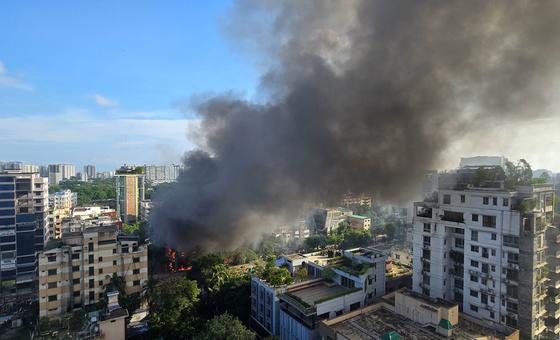 Smoke rises from a store set on fire by protestors in Dhaka, Bangladesh.