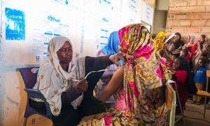 Health workers screen children and pregnant women for malnutrition at a shelter for displaced families in Gedaref state, Sudan.