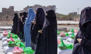 अफ़ग़ानिस्तान के हेरात में एक खाद्य वितरण केन्द्र पर, कुछ महिलाएँ खाद्य सामग्री प्राप्त करते हुए.