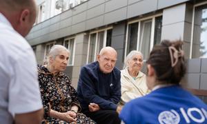 Yuri (centre) and two women are counselled by an IOM staff member. 