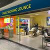 Passengers smoke in a designated lounge at Frankfurt airport in Germany.