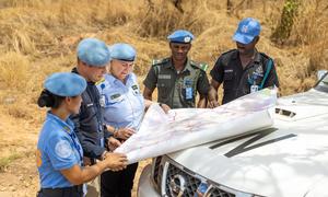 Police officers deployed to the UN peacekeeping mission in South Sudan consult a map. 