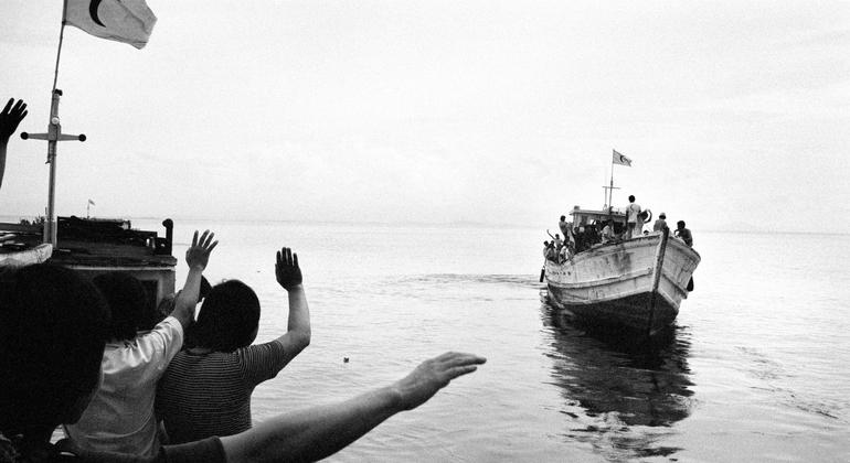 Vietnamese refugees (foreground) bid farewell to other refugees who are leaving for Malaysia.