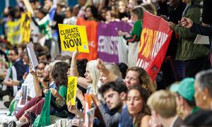 People advocate for action at a global meeting on climate change in Baku, Azerbaijan.