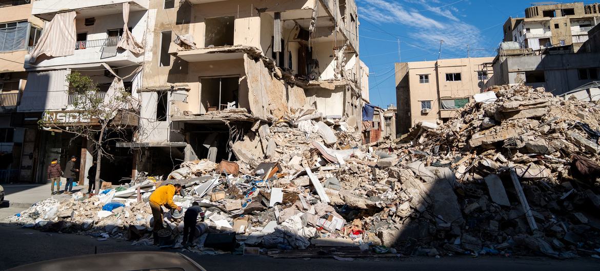 People search through the rubble of a bombed building in Tyre in southern Lebanon. 