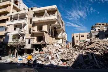 People search through the rubble of a bombed building in Tyre in southern Lebanon. 