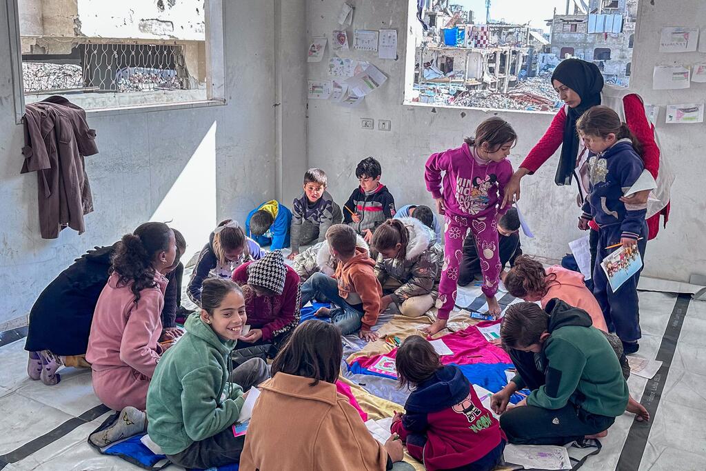 Children play under the supervision of a counselor in Jabalya, North Gaza.
