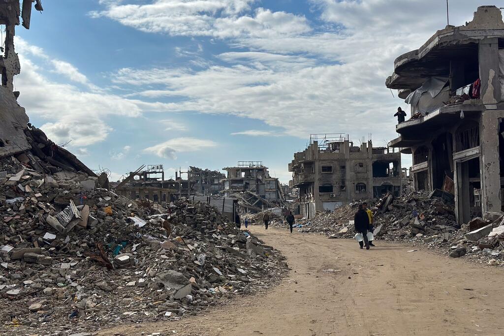 La gente camina por el barrio en gran parte destruido de Jabalya, en el norte de Gaza.