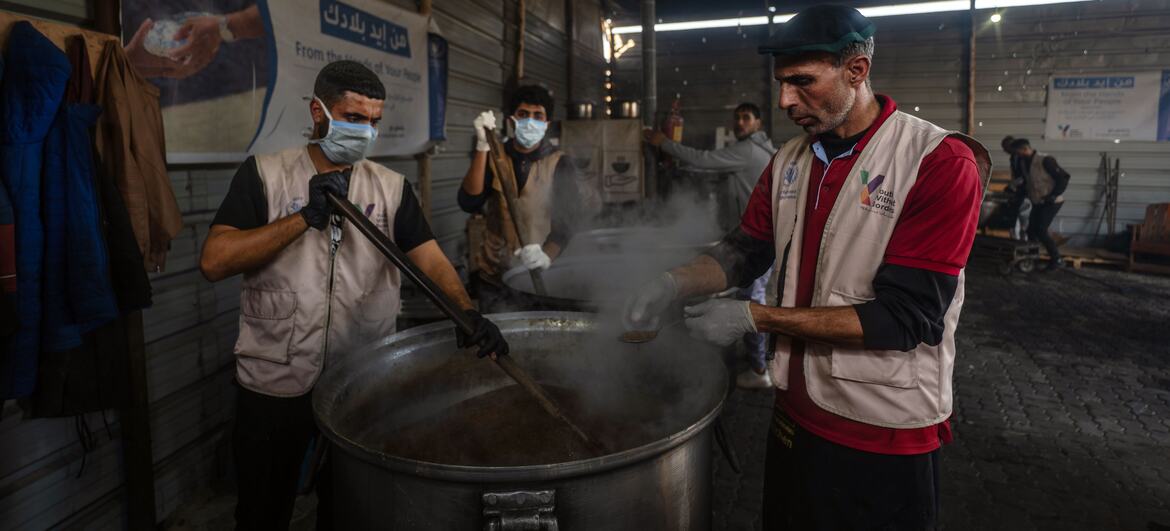 Abu Muhammad, chef en una cocina de comidas calientes con el apoyo del PMA en Khan Younis, inspecciona los alimentos preparados por sus colegas mientras ayuda a servir más de 11.000 comidas diarias a las familias afectadas por la guerra en Gaza.
