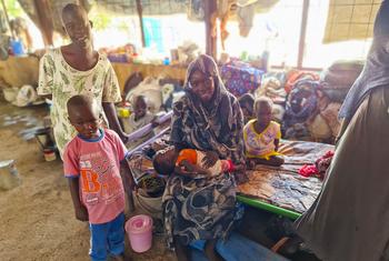 A family affected  by conflict settle at a gathering site for internally displaced people in Aj Jazirah, Sudan.