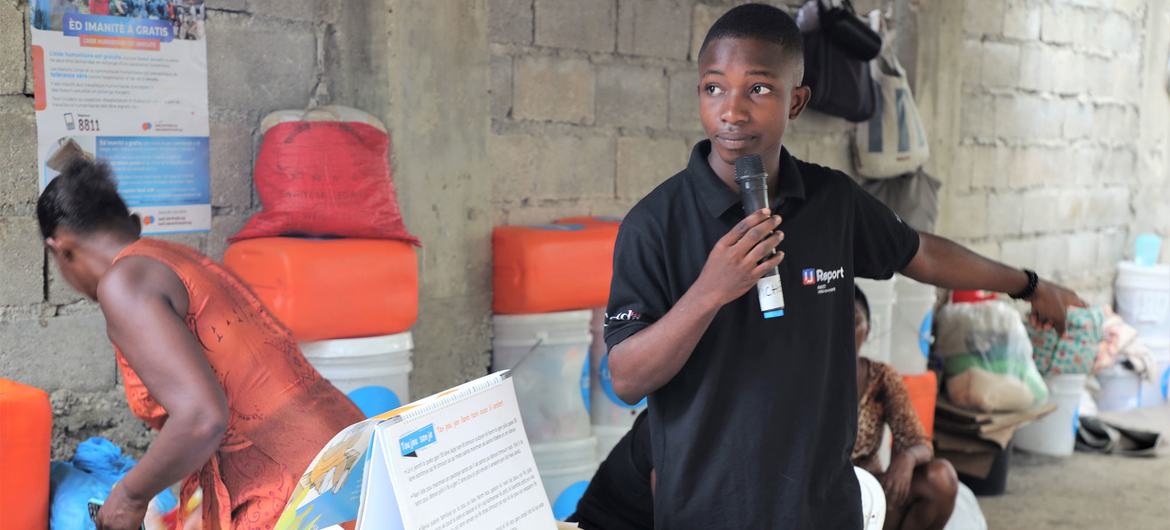 A U-reporter gives a presentation on proper hygiene practices and cholera prevention.