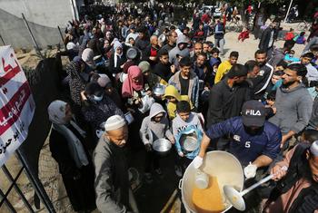 مجموعة من أهالي غزة يصطفون من أجل الحصول على الغذاء.