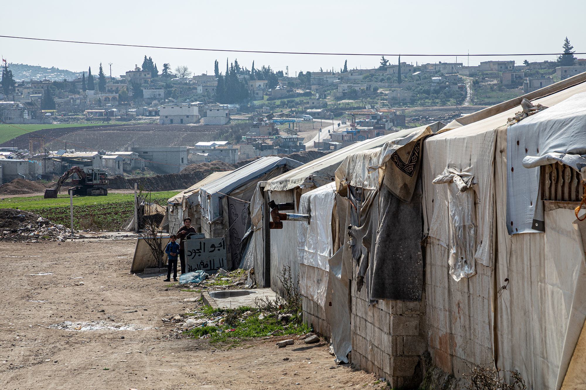 Temporary shelters stand in rows in rural Aleppo in Syria.