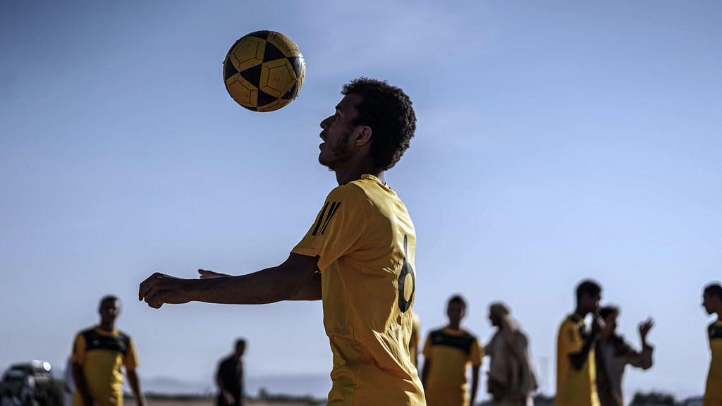Player in football tournament for displaced people in Ma'rib, Yemen