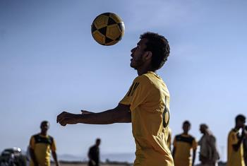 Player in football tournament for displaced people in Ma'rib, Yemen
