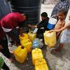 Children collect water in the Gaza Strip.
