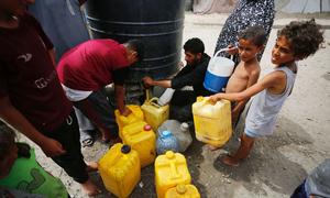 Children collect water in the Gaza Strip.