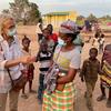 UN Resident Coordinator Myrta Kaulard talks with the mother of a student after the opening of a new school building with UN support in Monapo District, Nampula province, Mozambique, in 2022.