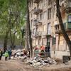 People gather around a damaged building in Kyiv, Ukraine.