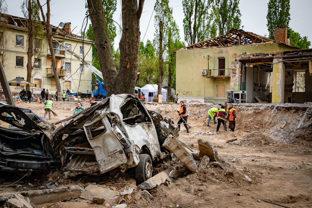 Workers clear debris following attacks in Kyiv, Ukraine, in April 2025.