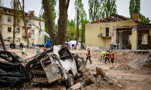 Workers clear debris following attacks in Kyiv, Ukraine, in April 2025.