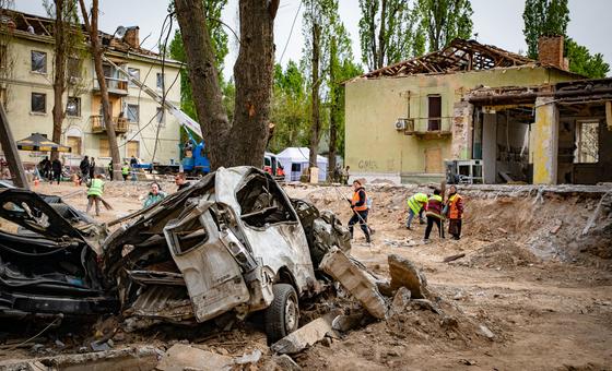 Workers clear debris following attacks in Kyiv, Ukraine, in April 2025.
