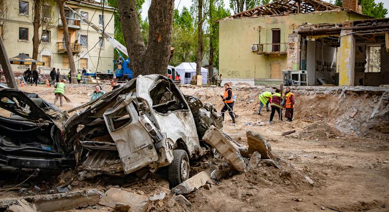Workers clear debris following attacks in Kyiv, Ukraine, in April 2025.