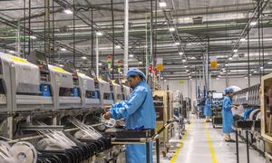 Workers at a factory in Laos assemble electronic products for export.