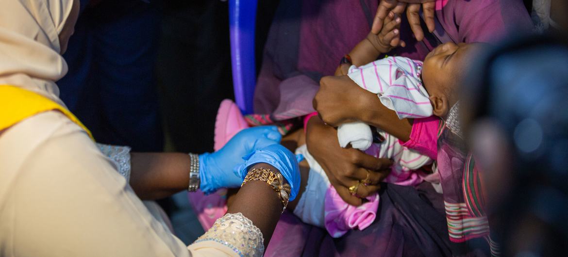 A baby receives a malaria vaccine in Sudan.