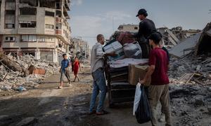 Men load possessions onto a cart in the al-Naser area of Gaza City.