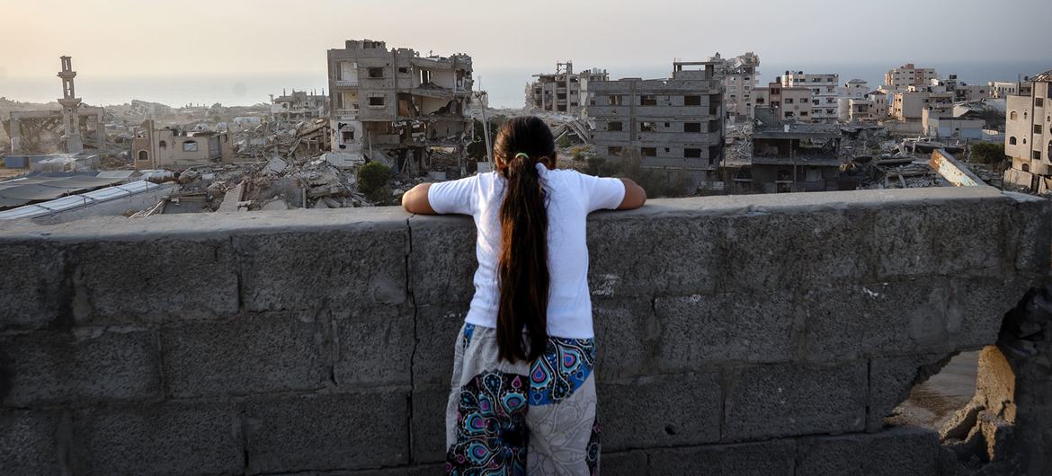 A girl looks over the destruction of Gaza City.