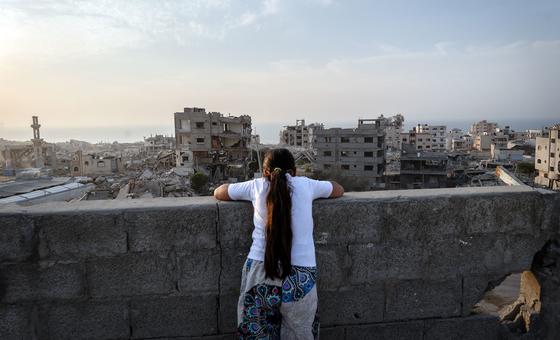A girl looks over the destruction of Gaza City.