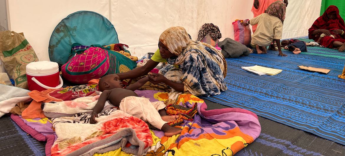 A mother who fled across the Sudanese border to Chad cares for her malnourished child. 