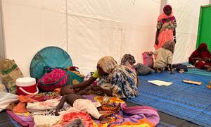 A mother who fled across the Sudanese border to Chad cares for her malnourished child. 