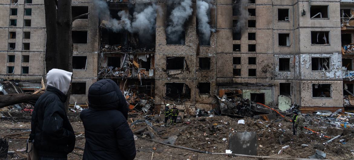 People watch a building on fire following a missile attack in Ukraine. (file)