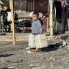 一个小男孩在加沙地带搬运水罐。