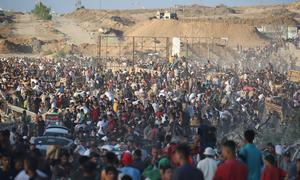 People gather in the vicinity of a food distribution by the Gaza Humanitarian Foundation (GHF).