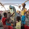 Refugees fleeing Sudan build a temporary shelter at the border with South Sudan. 