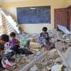 Boys study in what used to be their classroom in Al Khair school, in Taiz governorate, Yemen.