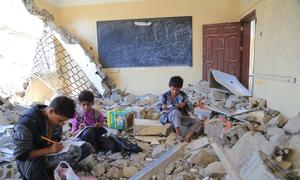 Boys study in what used to be their classroom in Al Khair school, in Taiz governorate, Yemen.