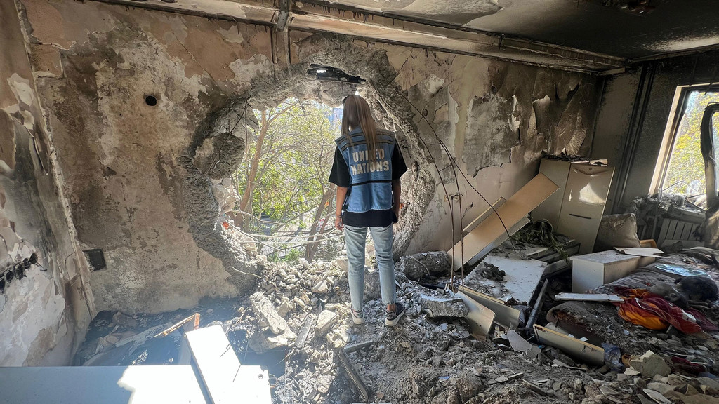 一名联合国工作人员正在乌克兰检查一栋在持续对俄战争中受损的建筑。