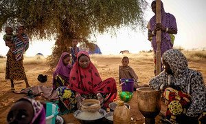 Displaced women prepare food at an informal camp in Bagoundié, Mali.