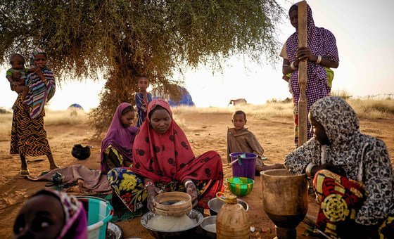 Displaced women prepare food at an informal camp in Bagoundié, Mali.