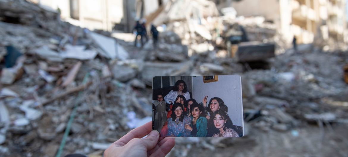 In the Jableh district in northwestern Syria, a photo of a family hangs in front of the building where they used to live.