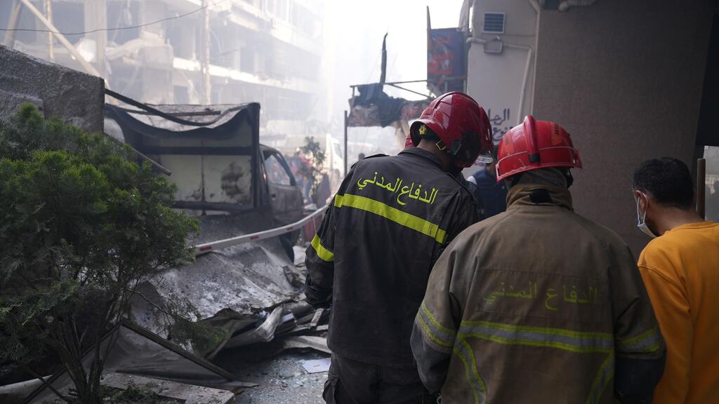Firefighters survey a scene of destruction in Beirut, Lebanon.